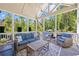 Relaxing screened-in porch with ample seating and views of the lush greenery at 3111 Old Thompson Mill Rd, Buford, GA 30519