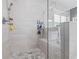 Modern shower with a seat, tiled walls, and a glass enclosure at 3111 Old Thompson Mill Rd, Buford, GA 30519