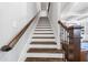 Elegant staircase featuring dark wood treads, white risers and decorative railings at 3111 Old Thompson Mill Rd, Buford, GA 30519