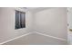 Simple bedroom with neutral paint and trim, a window, and wood door at 3434 Saddlebrook Dr, Loganville, GA 30052