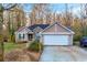 Charming one-story home featuring a two-car garage, stone accents, and a well-manicured front yard at 3434 Saddlebrook Dr, Loganville, GA 30052