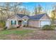 Inviting single-story home with stone accents and a well-maintained lawn, perfect for curb appeal at 3434 Saddlebrook Dr, Loganville, GA 30052