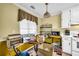Cozy eat-in kitchen with window, featuring white appliances, bright yellow walls, and hanging light fixture at 3434 Saddlebrook Dr, Loganville, GA 30052