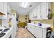 Bright kitchen featuring ample counter space, white cabinets, and essential appliances at 3434 Saddlebrook Dr, Loganville, GA 30052