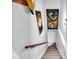 Stairway featuring wall art, a wooden handrail, and carpeted steps leading to the next level at 3434 Saddlebrook Dr, Loganville, GA 30052