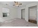 Bedroom featuring a ceiling fan, neutral carpet, and natural light at 3716 Vineyards Lake Nw Cir # U-2, Kennesaw, GA 30144