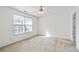 Spacious bedroom with a ceiling fan and natural light from the window at 3716 Vineyards Lake Nw Cir # U-2, Kennesaw, GA 30144