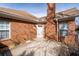 Back exterior view highlighting brick facade and door to patio area at 3716 Vineyards Lake Nw Cir # U-2, Kennesaw, GA 30144