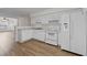 Functional kitchen featuring white appliances, cabinets, and wood-look flooring at 3716 Vineyards Lake Nw Cir # U-2, Kennesaw, GA 30144