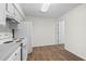 Compact kitchen featuring white cabinets and a matching white appliance package at 3716 Vineyards Lake Nw Cir # U-2, Kennesaw, GA 30144