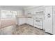 Well-lit kitchen features white cabinetry and modern appliances at 3716 Vineyards Lake Nw Cir # U-2, Kennesaw, GA 30144