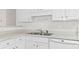 Clean kitchen features white cabinets and a stainless steel sink at 3716 Vineyards Lake Nw Cir # U-2, Kennesaw, GA 30144