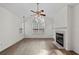 Bright living room featuring vaulted ceilings, fireplace, large windows, and wood-look flooring at 3716 Vineyards Lake Nw Cir # U-2, Kennesaw, GA 30144