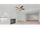 Inviting living room with a charming fireplace, a ceiling fan, and bright natural light at 3716 Vineyards Lake Nw Cir # U-2, Kennesaw, GA 30144