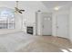 Open-concept living room featuring a fireplace, ceiling fan, and easy access to the entry at 3716 Vineyards Lake Nw Cir # U-2, Kennesaw, GA 30144