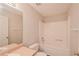 Neutral bathroom with a shower-tub, white vanity, and door at 6595 Browns Mill Ferry Dr, Lithonia, GA 30038