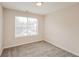 Cozy bedroom with a large window to bring in natural light and plush carpet at 6595 Browns Mill Ferry Dr, Lithonia, GA 30038