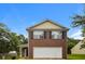 Two story brick home with a two car garage and manicured front lawn underneath a blue sky at 6595 Browns Mill Ferry Dr, Lithonia, GA 30038