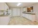 This kitchen features white cabinets, linoleum floors and white appliances at 6595 Browns Mill Ferry Dr, Lithonia, GA 30038