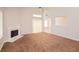 This living room features carpeted floors, a fireplace, and sliding doors leading to the outside at 6595 Browns Mill Ferry Dr, Lithonia, GA 30038