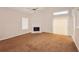 Bright living room features high ceilings, carpeted floors, a fireplace, and sliding doors leading to the outside at 6595 Browns Mill Ferry Dr, Lithonia, GA 30038