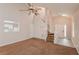 Bright living room features high ceilings, wood and carpeted floors, and a staircase to the upper level at 6595 Browns Mill Ferry Dr, Lithonia, GA 30038