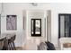 Bright hallway with hardwood floors leading to glass doors and a dark-framed wine storage unit at 1273 Danner Se St, Atlanta, GA 30316
