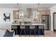 Modern kitchen with stainless steel appliances, a large island with bar seating, and light wood cabinets at 1273 Danner Se St, Atlanta, GA 30316