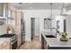 Well-designed kitchen with stainless steel appliances, an island with sink, and light wood cabinets at 1273 Danner Se St, Atlanta, GA 30316