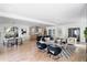 Open-concept living room featuring hardwood floors, modern furniture, and a stylish kitchen in the background at 1273 Danner Se St, Atlanta, GA 30316