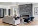 Modern living room with a striking gray fireplace, hardwood floors, and contemporary furnishings at 1273 Danner Se St, Atlanta, GA 30316