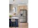 Kitchen featuring stainless steel refrigerator, marble countertops, designer lighting, and light wood cabinetry at 1273 Danner Se St, Atlanta, GA 30316