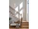 Bright foyer showcasing an open staircase with wood steps, black iron railings, and a cozy bench at 1273 Danner Se St, Atlanta, GA 30316