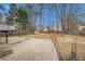 Large backyard featuring mature trees, a shed, a fire pit, and fencing at 1474 Benjamin Sw Ct, Marietta, GA 30064