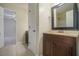 Bathroom with a dark wood vanity, framed mirror, and tile flooring at 1474 Benjamin Sw Ct, Marietta, GA 30064