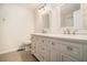 Bright bathroom featuring a double vanity with decorative mirrors and stylish fixtures at 1474 Benjamin Sw Ct, Marietta, GA 30064