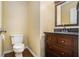 Cozy half bath features a classic vanity with dark wood finish and granite top at 1474 Benjamin Sw Ct, Marietta, GA 30064