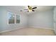 Light-filled bedroom with neutral carpet, a ceiling fan, and a large window at 1474 Benjamin Sw Ct, Marietta, GA 30064