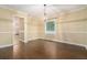 Inviting dining room with hardwood floors, chandelier, and a large window with a peaceful view at 1474 Benjamin Sw Ct, Marietta, GA 30064