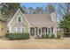 Charming home featuring a well-manicured front yard, a quaint porch, and a classic suburban aesthetic at 1474 Benjamin Sw Ct, Marietta, GA 30064