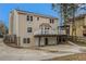Tan two story house with a deck, lower level garage, and paved driveway at 1474 Benjamin Sw Ct, Marietta, GA 30064