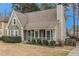 Traditional home with a well-kept lawn, inviting porch, and classic architectural details at 1474 Benjamin Sw Ct, Marietta, GA 30064