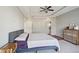 Bright bedroom featuring a ceiling fan, tray ceiling, dresser, patterned rug and natural light at 2029 Havenhurst Way, Auburn, GA 30011