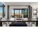 Dining area with a dark wood table, a comfortable bench, and a view of the outdoor living space at 13425 Bishops Ct, Roswell, GA 30075