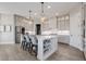 Well-lit kitchen featuring an island with seating and modern appliances at 13425 Bishops Ct, Roswell, GA 30075