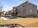 Exterior view of brick home with a pool, pavilion, tiered landscape, and expansive backyard at 13425 Bishops Ct, Roswell, GA 30075