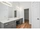 Bathroom with double sink vanity with cabinets and large mirror at 2794 Hillvale Cove Way, Lithonia, GA 30058