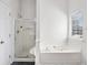 Bright bathroom with glass enclosed shower and soaker tub by window at 2794 Hillvale Cove Way, Lithonia, GA 30058