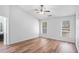 Bright bedroom with hardwood floors, ceiling fan and two sunny windows at 2794 Hillvale Cove Way, Lithonia, GA 30058