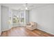 Bedroom featuring hardwood floors, bay window and chair at 2794 Hillvale Cove Way, Lithonia, GA 30058